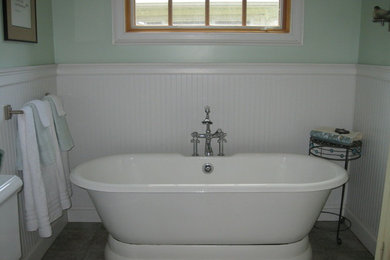 Imagen de cuarto de baño principal tradicional renovado con bañera exenta, paredes verdes y suelo de baldosas de porcelana