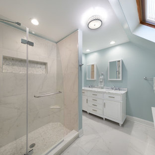 Ispirazione per una stanza da bagno padronale moderna di medie dimensioni con ante con bugna sagomata, ante bianche, vasca freestanding, doccia ad angolo, WC monopezzo, piastrelle bianche, lastra di pietra, pareti blu, pavimento in marmo, lavabo sottopiano e top in marmo
