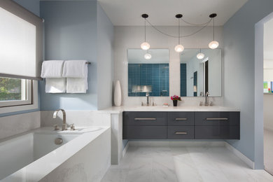 Mid-sized minimalist master beige tile and glass tile marble floor and white floor bathroom photo in San Francisco with beaded inset cabinets, gray cabinets, a one-piece toilet, blue walls, an integrated sink, quartz countertops and a hinged shower door
