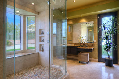 Design ideas for a large contemporary ensuite bathroom in Phoenix with a vessel sink, flat-panel cabinets, dark wood cabinets, granite worktops, a walk-in shower, a one-piece toilet, beige tiles, stone tiles, green walls and travertine flooring.