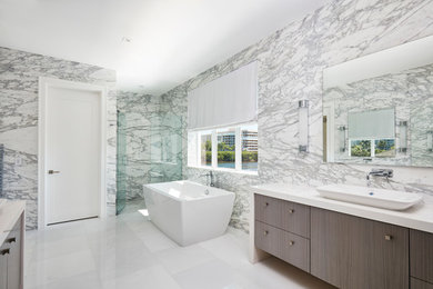 Inspiration for a large contemporary master white tile and stone tile marble floor and white floor bathroom remodel in Miami with medium tone wood cabinets, a vessel sink, wood countertops and gray walls