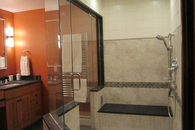 Example of a large transitional master gray tile and porcelain tile ceramic tile corner shower design in Boston with an undermount sink, shaker cabinets, light wood cabinets, soapstone countertops, a two-piece toilet and orange walls