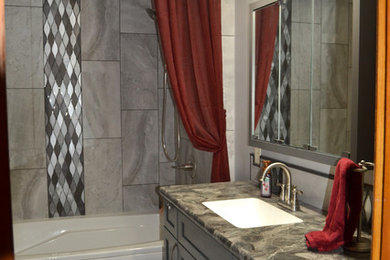 Photo of a medium sized classic ensuite bathroom in Other with flat-panel cabinets, grey cabinets, a freestanding bath, a shower/bath combination, a two-piece toilet, grey tiles, porcelain tiles, grey walls, porcelain flooring, a submerged sink, laminate worktops, grey floors, a shower curtain and grey worktops.