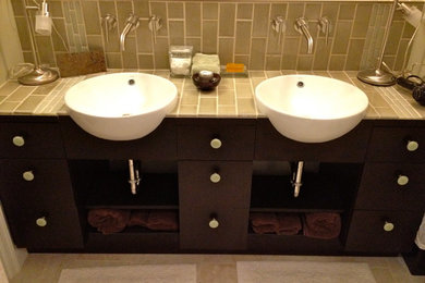 Mid-sized trendy porcelain tile and beige floor bathroom photo in DC Metro with flat-panel cabinets, dark wood cabinets, a vessel sink and tile countertops