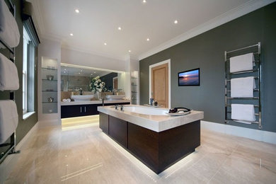 This is an example of a large modern bathroom in Dorset with a built-in sink, freestanding cabinets, dark wood cabinets, marble worktops, a built-in bath, a walk-in shower, a wall mounted toilet, beige tiles, ceramic tiles, grey walls and ceramic flooring.