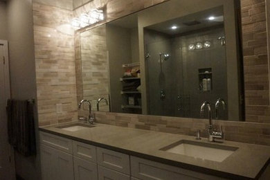Trendy master beige tile and stone tile porcelain tile bathroom photo in Seattle with an undermount sink, shaker cabinets, white cabinets, quartz countertops, a two-piece toilet and gray walls