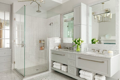 Trendy white tile corner shower photo in St Louis with an undermount sink, shaker cabinets, white cabinets and gray countertops