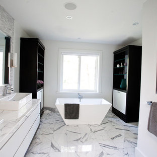 Immagine di una grande stanza da bagno padronale moderna con vasca freestanding, top in marmo, lavabo a bacinella, ante lisce, ante bianche, piastrelle bianche, piastrelle in pietra, pareti grigie e pavimento in marmo