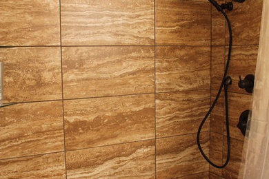 Example of a mid-sized transitional brown tile and ceramic tile ceramic tile and brown floor bathroom design in Other with brown walls