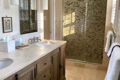 Alcove shower - mid-sized transitional master beige tile, brown tile, multicolored tile and ceramic tile ceramic tile and beige floor alcove shower idea with a two-piece toilet, gray walls, an undermount sink, a hinged shower door and beige countertops