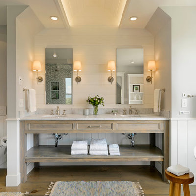Example of a cottage master freestanding bathtub design in Burlington with an undermount sink, open cabinets, distressed cabinets, a wall-mount toilet and white walls