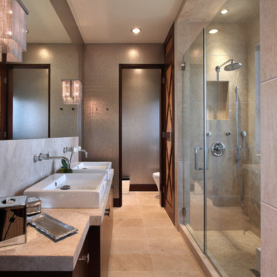 Trendy beige tile alcove shower photo in Orange County with a vessel sink, flat-panel cabinets and dark wood cabinets