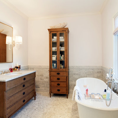 Freestanding bathtub - mid-sized traditional 3/4 gray tile and stone tile mosaic tile floor and gray floor freestanding bathtub idea in Austin with an undermount sink, furniture-like cabinets, dark wood cabinets, white walls and quartzite countertops