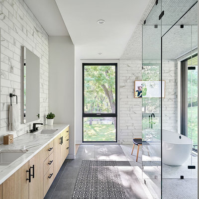 Trendy master gray tile and white tile gray floor bathroom photo in Kansas City with flat-panel cabinets, light wood cabinets, an undermount sink and white countertops