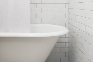 Claw-foot bathtub - small transitional white tile and subway tile gray floor and single-sink claw-foot bathtub idea in New York with a wall-mount sink and a floating vanity