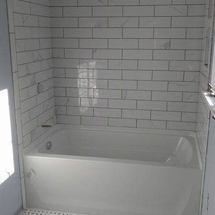 Photo of a small traditional 3/4 bathroom in Orange County with an alcove tub, a shower/bathtub combo, gray tile, white tile, subway tile, blue walls and linoleum floors.