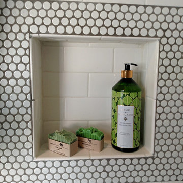 Subway tile with Penny tile accents and floor in a family bathroom.