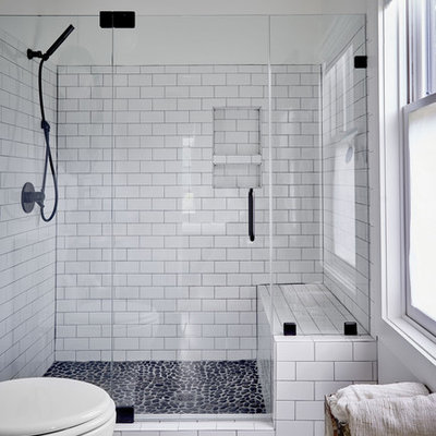 Inspiration for a mid-sized cottage white tile and porcelain tile pebble tile floor and gray floor alcove shower remodel in Other with white walls and a hinged shower door