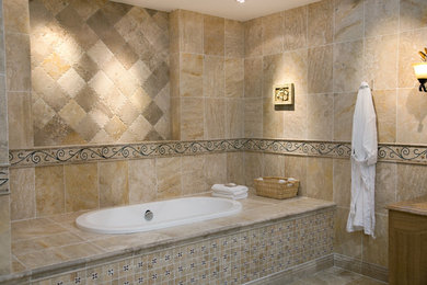 Drop-in bathtub - mid-sized traditional master beige tile and ceramic tile ceramic tile and beige floor drop-in bathtub idea in Houston with medium tone wood cabinets, beige walls and granite countertops