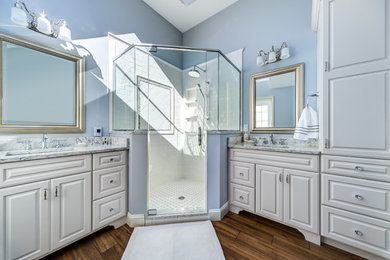 Inspiration for a mid-sized transitional master white tile and ceramic tile ceramic tile corner shower remodel in Boston with raised-panel cabinets, white cabinets, blue walls, an undermount sink and marble countertops