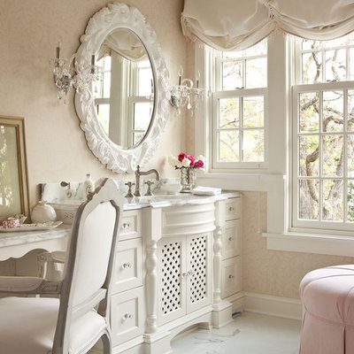 Example of a large cottage chic master marble floor corner shower design in Minneapolis with furniture-like cabinets, white cabinets, marble countertops and pink walls