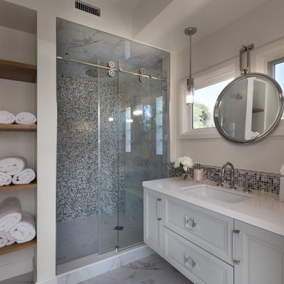 Inspiration for a mid-sized transitional 3/4 gray tile and mosaic tile white floor and marble floor bathroom remodel in Los Angeles with gray cabinets, white walls, an undermount sink, white countertops, raised-panel cabinets and quartz countertops