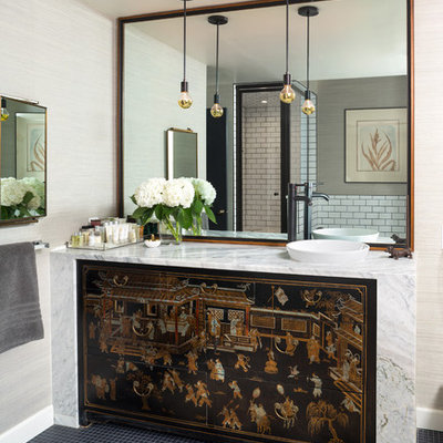 Corner shower - eclectic 3/4 white tile and subway tile corner shower idea in Denver with brown cabinets, beige walls, a vessel sink, a hinged shower door and white countertops
