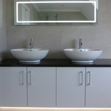 Super black granite worktop with twin Malaga countertop basins by Bauhaus. A fa