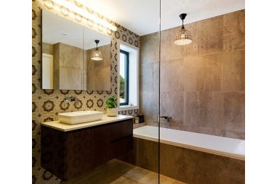 Design ideas for an eclectic bathroom in Melbourne with brown tile, porcelain tile, flat-panel cabinets, dark wood cabinets, a drop-in tub, an open shower, brown walls, porcelain floors, a vessel sink, engineered quartz benchtops, brown floor, an open shower and brown benchtops.