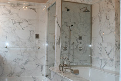 Inspiration for a large timeless master white tile and stone slab marble floor alcove shower remodel in New York with an undermount sink, furniture-like cabinets, dark wood cabinets, marble countertops, an undermount tub, a one-piece toilet and white walls