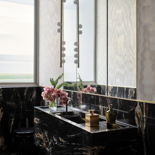 Large contemporary bathroom in Sydney with black tile, marble, marble benchtops and black benchtops.