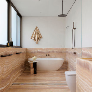 Photo of a large contemporary master bathroom in Sydney with onyx benchtops.