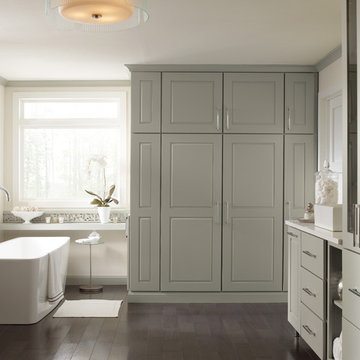 Tall bathroom with floor-to-ceiling cabinets and a console bathtub
