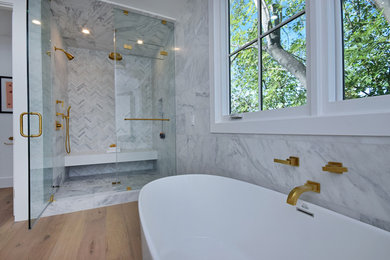 Large cottage master white tile and marble tile light wood floor and white floor bathroom photo in Los Angeles with flat-panel cabinets, white cabinets, a two-piece toilet, white walls, a drop-in sink, quartz countertops, a hinged shower door and white countertops