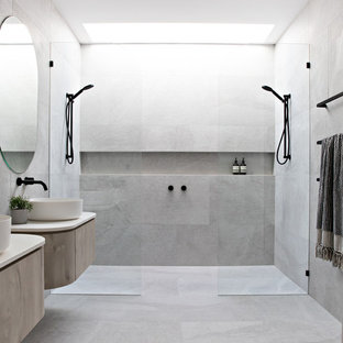 Inspiration for a contemporary bathroom in Gold Coast - Tweed with flat-panel cabinets, light wood cabinets, gray tile, a vessel sink, grey floor, an open shower, beige benchtops and a double shower.