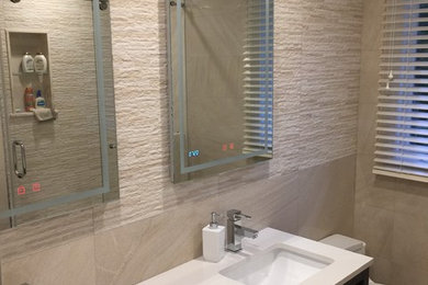 Example of a mid-sized minimalist kids' beige tile and porcelain tile porcelain tile and beige floor bathroom design in New York with furniture-like cabinets, dark wood cabinets, a one-piece toilet, beige walls, an undermount sink and quartzite countertops