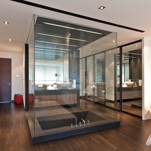 Contemporary bathroom in Singapore with flat-panel cabinets and a japanese tub.