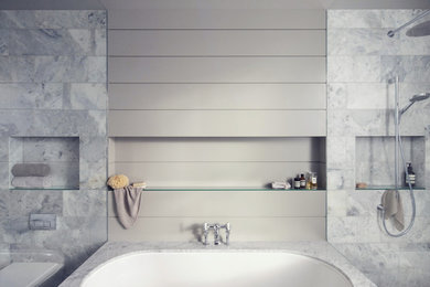 Inspiration for a large victorian ensuite wet room bathroom in London with recessed-panel cabinets, grey cabinets, a built-in bath, a wall mounted toilet, grey tiles, marble tiles, grey walls, an integrated sink, marble worktops, an open shower, mosaic tile flooring and grey floors.