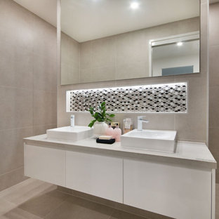 Mid-sized contemporary 3/4 bathroom in Gold Coast - Tweed with flat-panel cabinets, white cabinets, gray tile, porcelain tile, porcelain floors, a vessel sink, beige floor, grey benchtops and a niche.