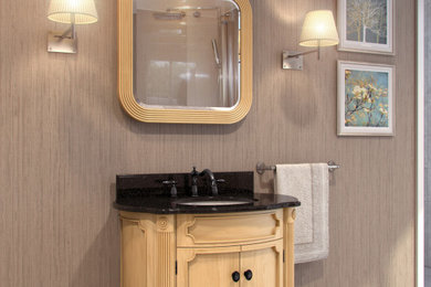 Example of a small classic beige tile and ceramic tile bathroom design with furniture-like cabinets, light wood cabinets, an undermount sink and granite countertops