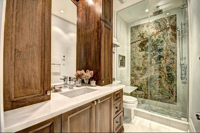 Small white tile and marble tile marble floor and white floor alcove shower photo in Toronto with furniture-like cabinets, medium tone wood cabinets, white walls, marble countertops, a hinged shower door and white countertops