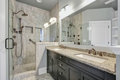 Large transitional master blue tile and porcelain tile porcelain tile bathroom photo in Other with furniture-like cabinets, dark wood cabinets, a two-piece toilet, gray walls, an integrated sink and granite countertops