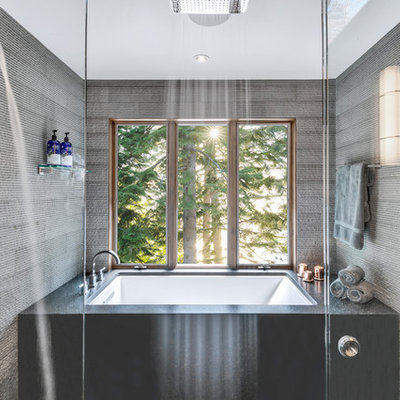 Large mountain style master gray tile and stone tile ceramic tile and gray floor bathroom photo in Other with furniture-like cabinets, brown cabinets, an undermount tub, a one-piece toilet, gray walls, a vessel sink, granite countertops and gray countertops