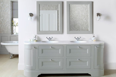 This is an example of a large traditional bathroom in Other with freestanding cabinets and solid surface worktops.