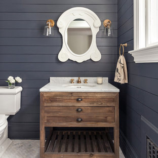 Inspiration for a transitional 3/4 mosaic tile floor and white floor bathroom remodel in New York with furniture-like cabinets, medium tone wood cabinets, a two-piece toilet, blue walls and an undermount sink