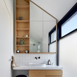 Inspiration for a contemporary master bathroom in Melbourne with white tile, white walls, ceramic floors, engineered quartz benchtops, grey floor, flat-panel cabinets, medium wood cabinets, a vessel sink and white benchtops.