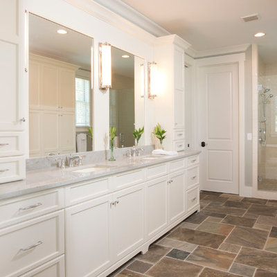 Inspiration for a large timeless master porcelain tile and brown floor alcove shower remodel in Charleston with an undermount sink, recessed-panel cabinets, white cabinets, gray walls, granite countertops, a two-piece toilet, a hinged shower door and gray countertops