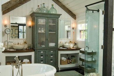 Cottage freestanding bathtub photo in Miami with a vessel sink, open cabinets and white cabinets