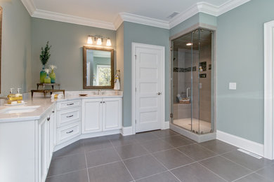 Large transitional master gray tile and ceramic tile ceramic tile and gray floor bathroom photo in Other with raised-panel cabinets, white cabinets, a two-piece toilet, gray walls, an undermount sink, granite countertops and a hinged shower door