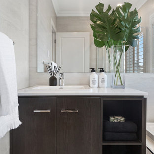 Mid-sized contemporary 3/4 bathroom in Gold Coast - Tweed with flat-panel cabinets, dark wood cabinets, gray tile, porcelain tile, a drop-in sink, white benchtops, a single vanity and a built-in vanity.